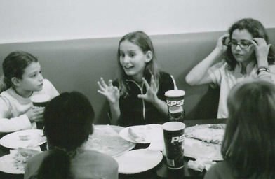 
                    The girls gossip about mischievous kids at school.
                                            (Maureen Wellner)
                                        
