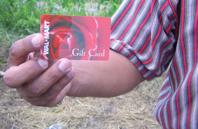 
                    Workers are given $10 gift cards to Wal-Mart for registering with the migrant program.
                                            (Kelly McEvers)
                                        