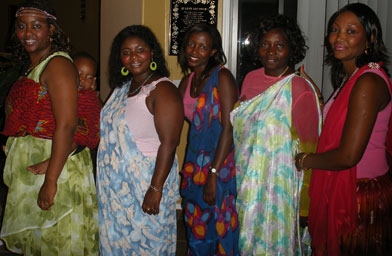 
                    Nadia Kassongo, Jeanne Nizigiyimana, Ines Kazeneza, Julie Ngiriye and Jackeline Simbandushe gather on the weekends at Jeanne's where they wear traditional clothes, cook food, sing Burundian songs and dance.
                                            (Ann Heppermann and Kara Oehler)
                                        
