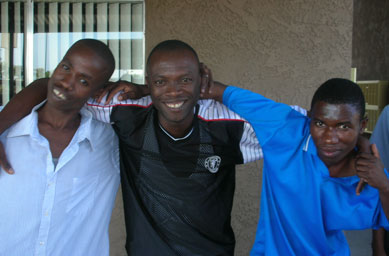 
                    Burundian men stand outside their apartment complex in Phoenix.  All three of the men have been relocated to Phoenix this summer.
                                            (Ann Heppermann and Kara Oehler)
                                        