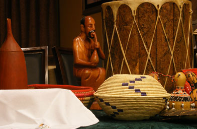 Jeanne displays traditional Burundian items on a table in her home.
(Ann Heppermann and Kara Oehler)