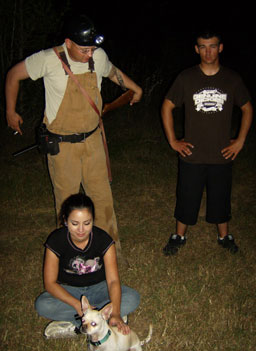 
                    Matt, Alex, April and another of their pet dogs sit around waiting for the hound to bark.
                                            (Michael May)
                                        
