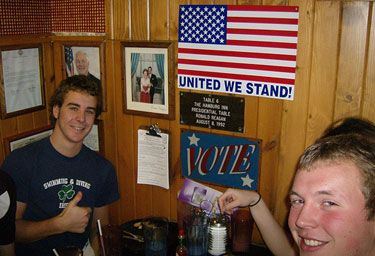 
                    Students from nearby University of Iowa sit at the table once occupied by Ronald Reagan. Reagan's 1992 visit to the 'Burg initiated its popularity with presidential candidates.
                                            (John Moe)
                                        