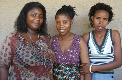 Jeanne, Jean and Claudine stand outside the two women's apartment in Phoenix. Jean and Claudine came to Phoenix from the refugee camps in Zambia a little over a year ago.
(Ann Heppermann and Kara Oehler)