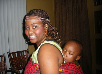 
                    The tradition in Burundi culture is to carry the baby on the back. Nadia Kassongo demonstrates with her son.
                                            (Ann Heppermann and Kara Oehler)
                                        