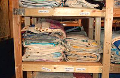 
                    Each panel is entered into a database for reference before being stored. Here, a close-up of one of the many shelves that hold these panels.
                                            (The NAMES Project Foundation, Atlanta, GA)
                                        