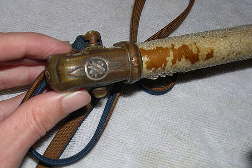 
                    The family crest, or "kamon," was likely put on the sword handle by the officer in order to customize it.
                                            (Krissy Clark)
                                        