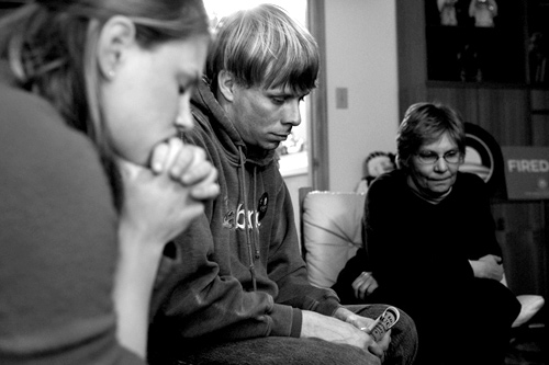 Obama Campaign field organizer Katie Malkin, Luke Haffner, and Irene Pfannkuch (left to right) listen to Senator Obama over a cell phone speakerphone. The Senator addressed pre-caucus events across the state through this one-way call.
(Sarah Mercier)