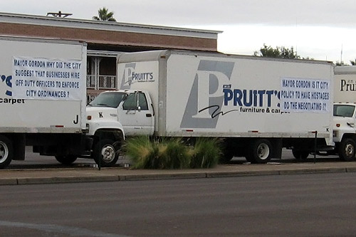 
                    A detail from one of the signs posted on the trucks barricading Pruitt's Furniture.
                                            (Karin Davies)
                                        