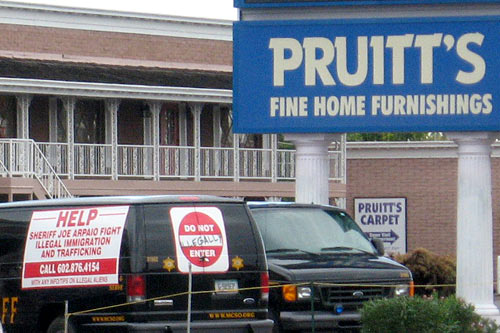 
                    The weekly demonstrations began after the owner of the furniture store asked off-duty Sheriff's deputies to patrol the parking lot to keep day laborers from loitering.
                                            (Karin Davies)
                                        