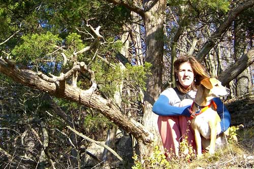 
                    Cronin and her dog Chloe on the bluffs over-looking the Missouri River Bottoms in Labadie, MO.The windblown cedar is a favorite of hers, which she visits often.
                                            (Courtesy Roxanne Cronin)
                                        