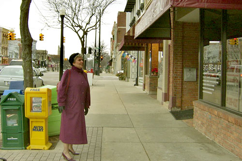 
                    Convery looks into a downtown Howell, Mich., storefront.
                                            (Desiree Cooper)
                                        