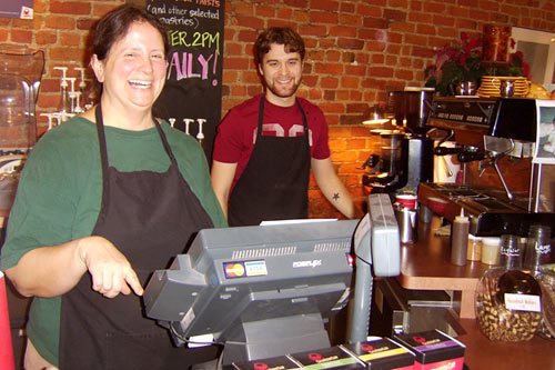 
                    Cate Doefer and David Goodyear work at the Uptown Coffeehouse in Howell, Mich. Doefer doesn't feel like she has to defend her community against the actions of a few "wackos."
                                            (Desiree Cooper)
                                        