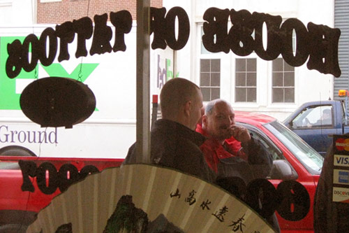 
                    Thompson shares a smoke with his buddies outside the House of Tattoos.
                                            (Shannon Mullen)
                                        