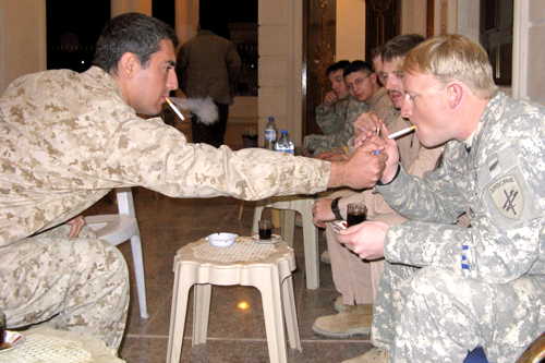 
                    Staff Sgt. Mark Hammerbacher has a smoke at the home of Sheik Raad Sabah Alwani, one of the influential Sunni leaders involved in the Anbar Awakening.
                                            (Adam Allington)
                                        
