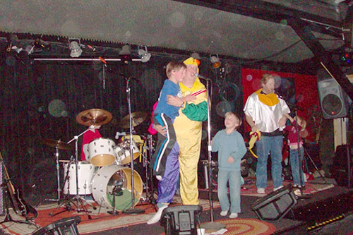 
                    Band members and their children on stage after Chicken Starship's final performance.
                                            (Jill Moe)
                                        