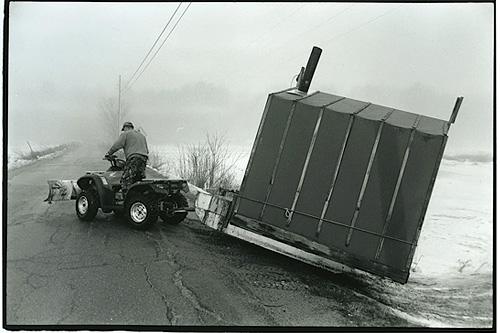 
                    Steve Leighton moves one of the 10 shacks he sets up every year on the Abagadasset River in Bowdoinham, Maine.
                                            (Sarah Breul/Salt Institute for Documentary Studies)
                                        