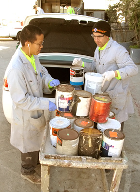 
                    Sunset Scavenger employees stack donated paint cans onto a rolling cart.
                                            (Nancy Mullane)
                                        