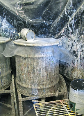 
                    Unused paint is poured into one of three 60-gallon barrels, depending on overall "tone."
                                            (Nancy Mullane)
                                        