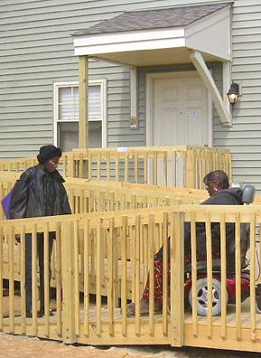 
                    Charnita leaves her house along with her daughter, Terrace Hurston, to go visit her sister, Helen. Wheelchair ramps have been built at the back of both sisters' houses.
                                            (Desiree Cooper)
                                        