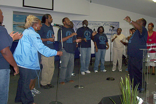 
                    The Worship Squad practices before their big debut at the Gospel Tent. The group taunts each other like family members. "They all are born again," Ron Hadley says. "They all are spirit-filled."
                                            (Lawrence Lanahan)
                                        