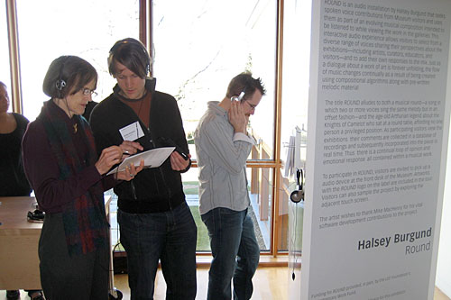 Halsey Burgund (center) explains his interactive art project to a museum patron.
(Courtesy Halsey Burgund)