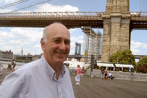 Weekend America guest and writer Phillip Lopate standing in front of the scaffolding for the Brooklyn Bridge waterfall.
(Sally Herships)