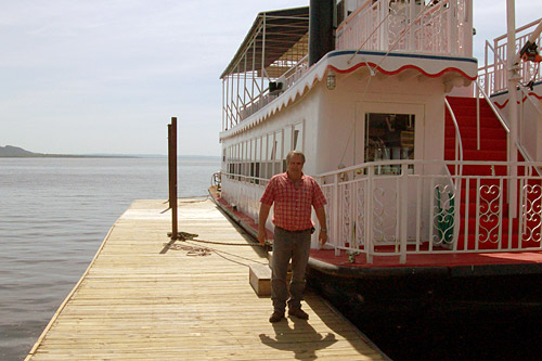 Larry Neilson owns two hotels plus this paddle boat. He's the one putting up a $50,000 reward for Pepie. He figures if he has to pay up and there really is a sea monster, it will be a good investment.
(John Moe)
