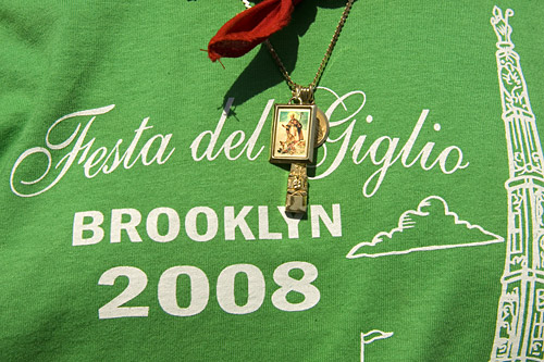 
                    A t-shirt commemorating the festival. The lift is a penance done in honor of San Paolino, the Bishop of Nola, Italy, and Our Lady of Mt. Carmel.
                                            (Michael Bocchieri)
                                        