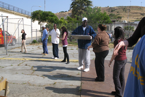 
                    Inmates and volunteers passing the food into the center for the TRUST food sale.
                                            (Nancy Mullane)
                                        