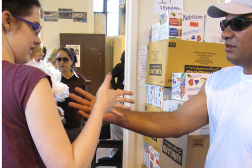 
                    Inmate Noel Valdivia teaches volunteer and university student Ashley Fisher some prison handshakes.
                                            (Nancy Mullane)
                                        