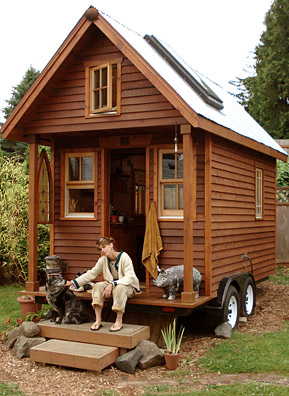 
                    Dee Williams sits with Rudy on the porch of her Tiny House.
                                            (Joshua McNichols)
                                        