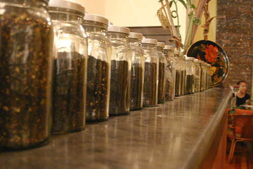 
                    The teahouse serves many teas from around the world, some of which are shown here, lined up in jars along the counter.
                                            (David Weinberg)
                                        