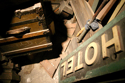 
                    Piled on the floor of the Panama's basement is the hotel's original wooden sign along with a dismantled pool table and an old trunk.
                                            (David Weinberg)
                                        