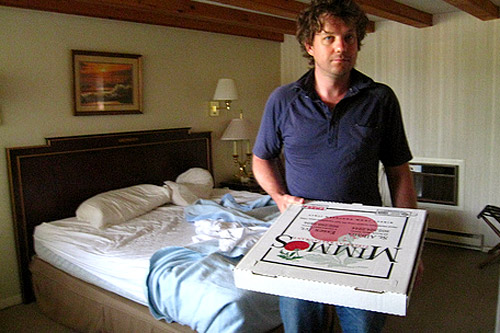 
                    The morning after the escape, Maxon holds leftover pizza at the Cadillac Motel as guilt is sets in.
                                            (Khanh Tran)
                                        