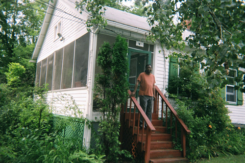 
                    Cornelius Eady stands outside the big house.
                                            (Sarah Micklem)
                                        
