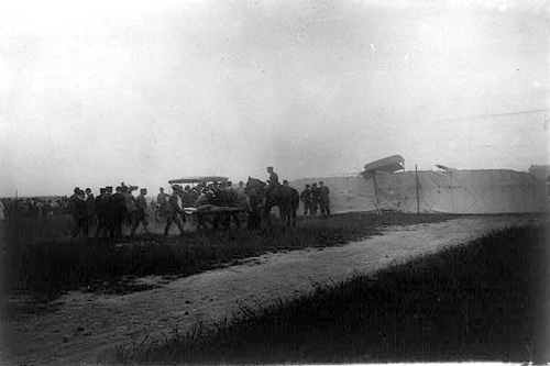 
                    The crowd pull the two men from the wreckage and patiently wait for the resident doctor to arrive.
                                            (Library of Congress)
                                        