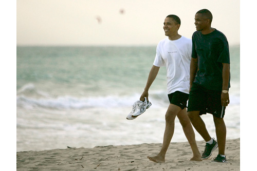 Sen. Barack Obama, D-Ill., walks down Kailua Beach in August with Marty Nesbitt, his friend and campaign treasurer. "It was actually a bit of a cloudy day, rays of sun shooting through the clouds on the water," photographer Mike Burley recalls. "Most people left him alone, and he continued walking along the beach. He had this look of relaxation on his face, he looked very happy to take a vacation."
(Mike Burley, The Honolulu Star-Bulletin)