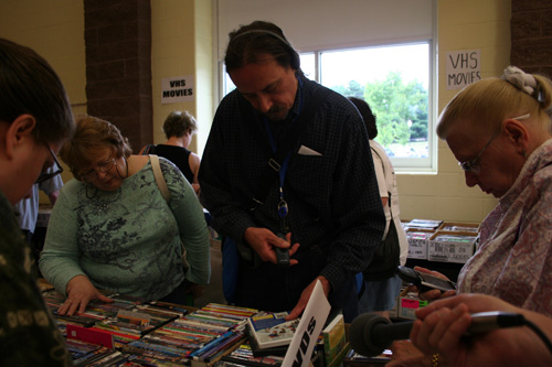 
                    Book sellers quickly scan the books at the sale, with or without PDAs.
                                            (Khanh Tran)
                                        