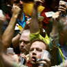 Traders in Chicago watch the Dow rise and fall.