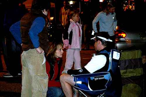 
                    In Concord, New Hampshire, there's a support rally waiting for John and Nate.  Nate's run about six  miles in terrible pain.  He discusses his options with his wife.
                                            (Sarah Chretien)
                                        