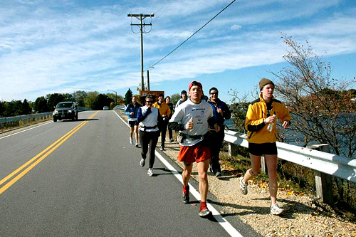 
                    With just a few miles to go, Nate and John are joined by a dozen strangers.  The sight of water ahead is a huge relief.  The smell of the salty sea energizes John.
                                            (Sarah Chretien)
                                        