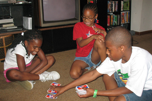 Nia,9, Ayanna, 7 and Mark Jr. play Skip Bo in the living room of their old house. Nia won.
(Laurie Stern)