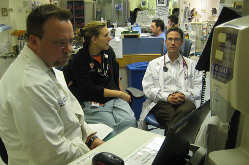 Dr. Jennifer Millen discusses a patient with the attending physician, who's in charge of the ER. In 6 months, when she finishes her residency in emergency medicine, she'll be the attending physician.
(Curt Nickisch)