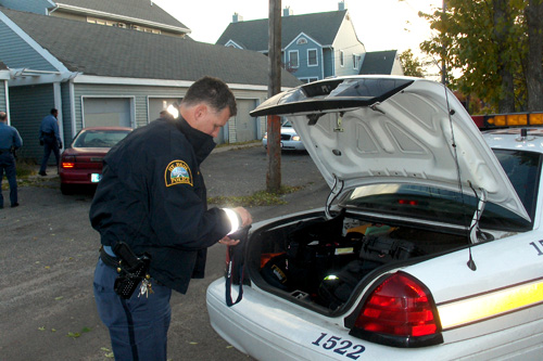 
                    Officer Lundquist fetches his camera.
                                            (Marc Sanchez)
                                        