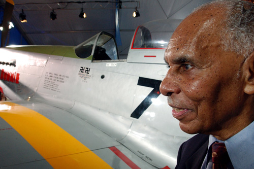 Captain Roscoe C. Brown stands next to the actual P-51 Mustang he flew as a member of the Tuskegee Airmen as part of a celebration ceremony honoring the 100th anniversary of the Wright brothers' flight. The two swastikas painted on the plane's side symbolize two Nazi planes he shot down during his 68 combat missions.
(Stephen Chernin/Getty Images)